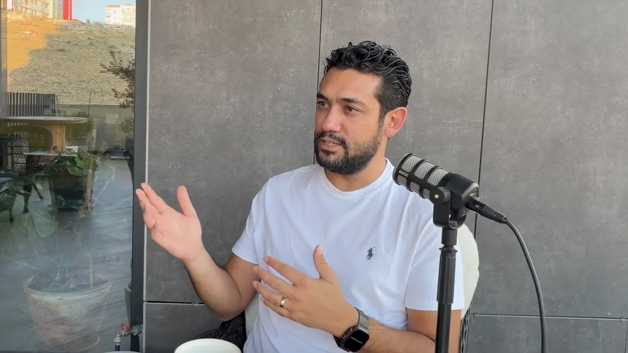 Evren Bayraktar raising an open hand while describing a teammate pasting screenshots into ChatGPT